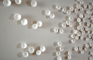 little clay cups art installation inspired by cherry blossom, modern organic installation of 200 wall sculptures ideal for interior design projects and corporate art.