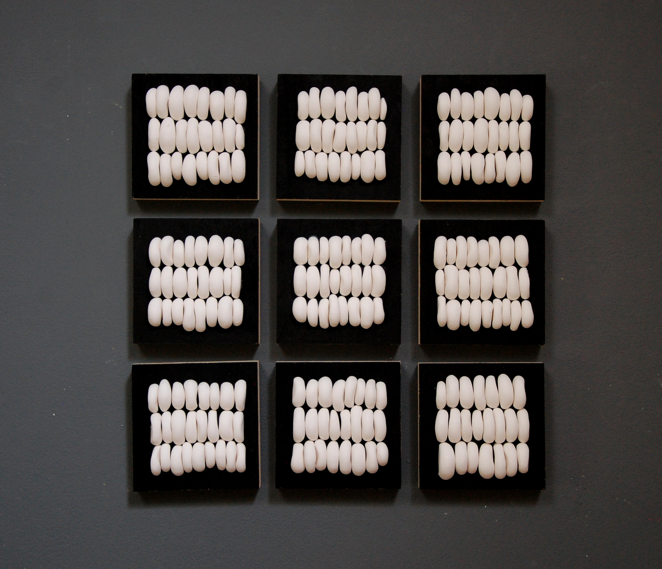 abstract dimensional wall art on wood blocks in black and white